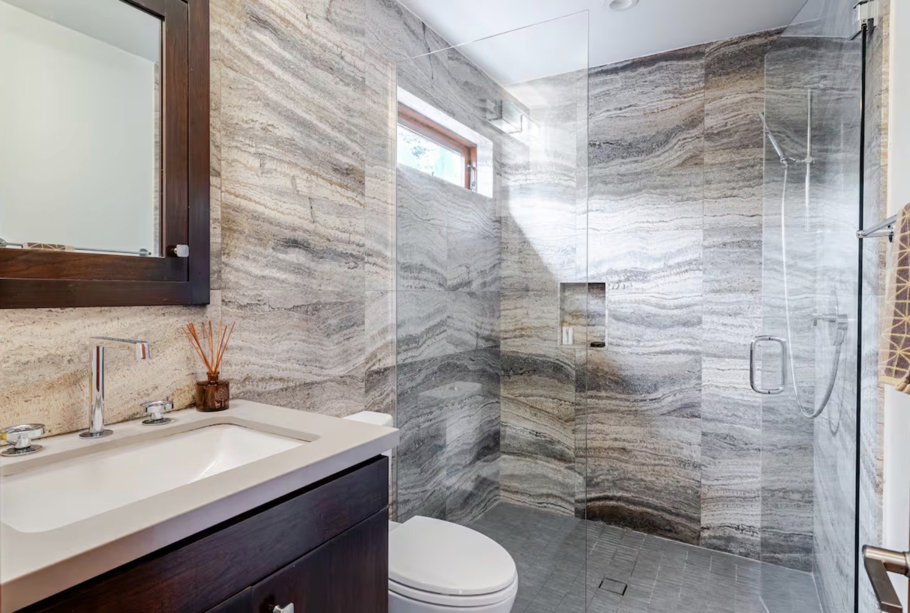 Travertine bathroom shower with custom vanity